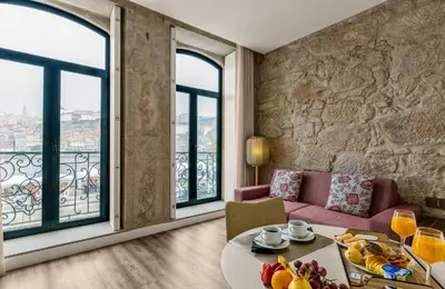 a living room with a couch and a table with fruit at 296 Heritage Apartments in Vila Nova de Gaia