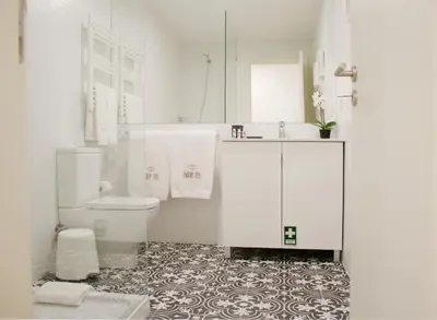 a white bathroom with a toilet and a sink at HM - Carlos Alberto Apartment 3 in Porto