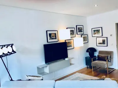 a living room with a flat screen tv on a white wall at Oporto Chic&Cozy - S. Bento in Porto