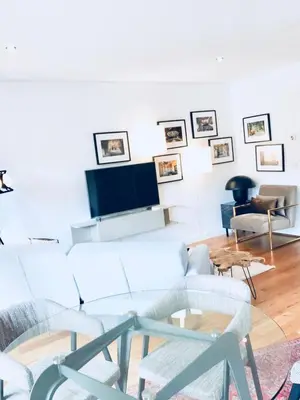 a living room with white furniture and a flat screen tv at Oporto Chic&Cozy - S. Bento in Porto