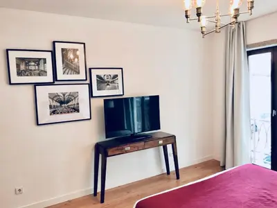 a bedroom with a tv and a table with a television at Oporto Chic&Cozy - S. Bento in Porto