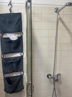 a shower with three shelves in a shower stall at Sao Bento Studio in Porto
