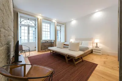 a living room with a bed and a couch at LovelyStay - Rico's Apartment - Almada 1ºF in Porto