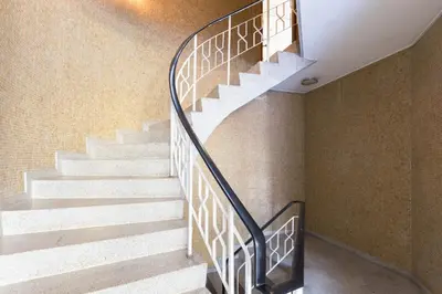 a staircase with a metal railing in a building at Gaia Metro-2 Bedrooms in Vila Nova de Gaia