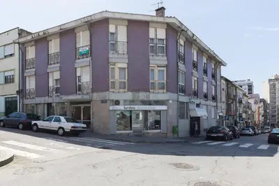 a tall building with cars parked in front of it at Gaia Metro-2 Bedrooms in Vila Nova de Gaia