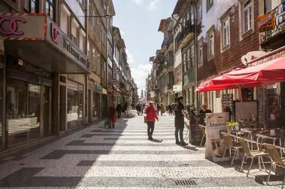 a group of people walking down a city street at Cozy Stay - Cedofeita 436 in Porto