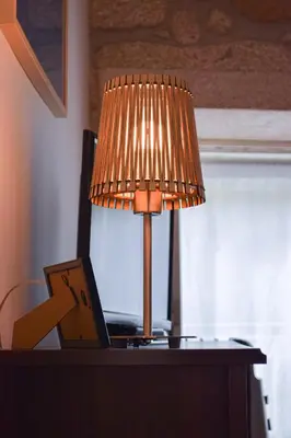a lamp on top of a desk with a laptop at Aurora Garden in Porto