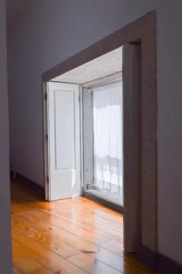 an open door to a room with a window at Aurora Garden in Porto