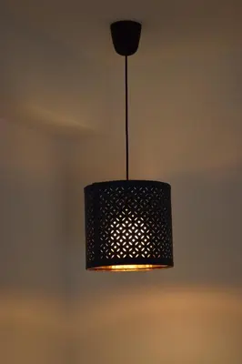 a black pendant light hanging from a ceiling at Aurora Garden in Porto