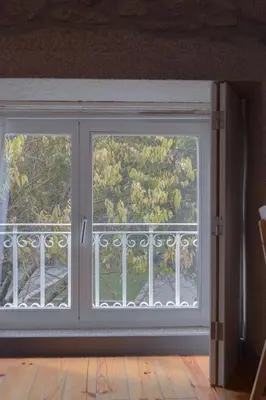 a sliding glass door with a window in a room at Aurora Garden in Porto
