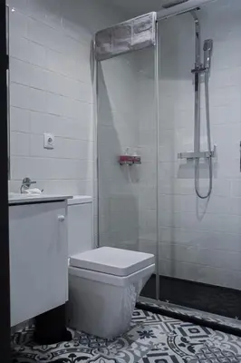 a bathroom with a shower and a toilet and a sink at Aurora Street in Porto