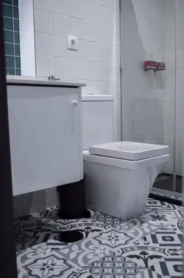 a white bathroom with a toilet and a shower at Aurora Street in Porto