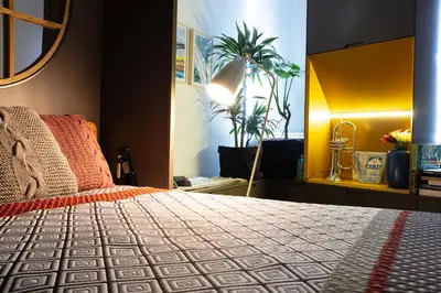 a bedroom with a bed and a potted plant at HOMEinTOWN Camões - Modern and Quiet Central Studio - AC & Fast WiFi Near Trindade Metro Station in Porto