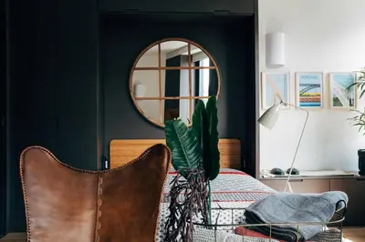 a bedroom with a table with a mirror and a chair at HOMEinTOWN Camões - Modern and Quiet Central Studio - AC & Fast WiFi Near Trindade Metro Station in Porto
