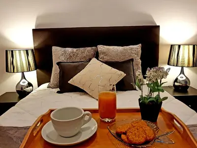 a bedroom with a bed with a coffee table with a cup of tea at Oporto Cozy Studio in Porto