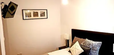 a bedroom with a bed and a picture on the wall at Oporto Cozy Studio in Porto
