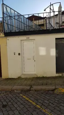 a white building with a white door and a balcony at Oporto Cozy Studio in Porto