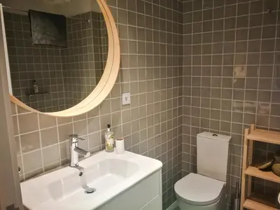 a bathroom with a sink and a toilet and a mirror at Cedofeita 408, Green in Porto