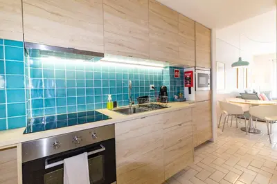 a kitchen with blue tiles on the wall and a sink at Cedofeita 408, Green in Porto