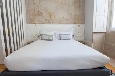 a large white bed with two pillows on it at Oporto City View - Santo Ildefonso Lovely in Porto