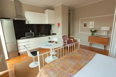 a small kitchen with a table and chairs in a room at Oporto City View - Santo Ildefonso Lovely in Porto