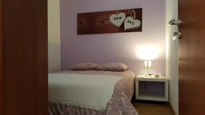 a bedroom with a bed with two hearts on the wall at O Ninho in Vila Nova de Gaia