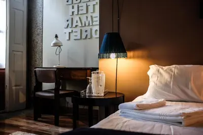 a bedroom with a bed and a table with a lamp at The Poets Inn in Porto