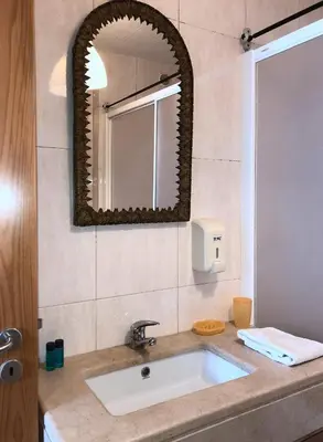 a bathroom with a sink and a mirror at The Poets Inn in Porto