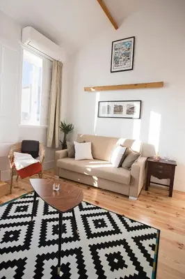 a living room with a couch and a table at Bonfim Apartment in Porto