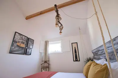 a bedroom with a swing bed and a window at Bonfim Apartment in Porto