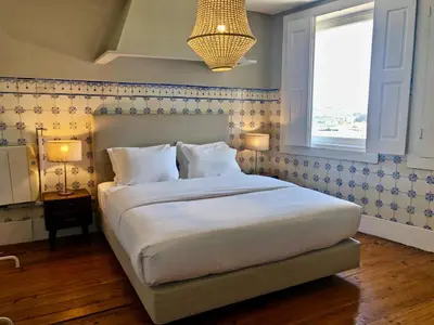a bedroom with a large bed and a window at Porto Republica Downtown in Porto