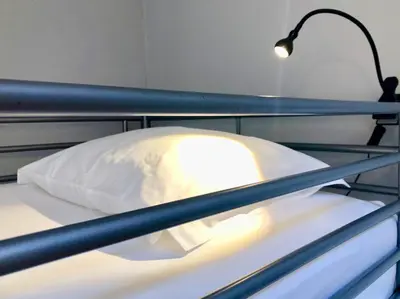 a bed with a pillow and a lamp on it at Porto Republica Downtown in Porto