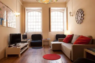a living room with a couch and a tv at Porto Republica Downtown in Porto