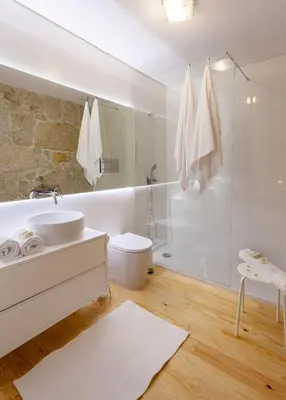 a white bathroom with a sink and a shower at Urban Views Townhouse Infante in Porto