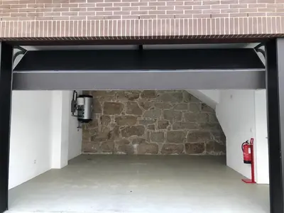 a black loft bed in front of a brick wall at Urban Views Townhouse Infante in Porto