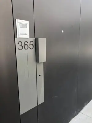 an elevator with a sign on the side of a building at Urban Views Townhouse Infante in Porto