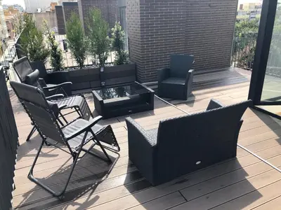 a balcony with chairs and a table and a fire pit at Urban Views Townhouse Infante in Porto