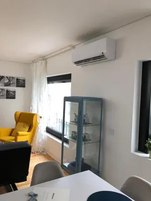 a living room with a yellow chair and a mirror at Urban Views Townhouse Infante in Porto