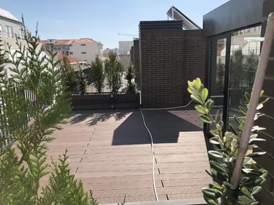 a patio with a wire on the side of a building at Urban Views Townhouse Arrábida in Porto