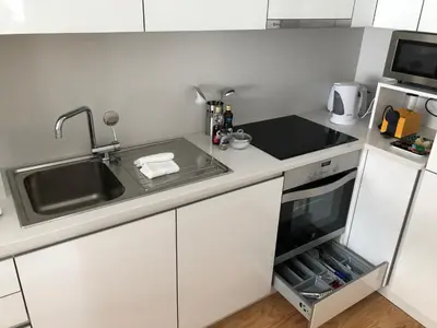 a small kitchen with a sink and a stove at Urban Views Townhouse Arrábida in Porto