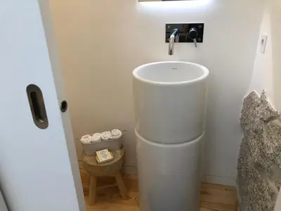 a white bathroom with a sink in a room at Urban Views Townhouse Arrábida in Porto