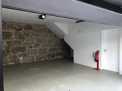 an empty room with a brick wall and a fire hydrant at Urban Views Townhouse Arrábida in Porto