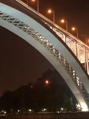 a bridge over a river at night at Urban Views Townhouse Arrábida in Porto