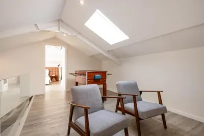 a room with two chairs and a table and a piano at Ribeira Apartments Santa Catarina in Porto