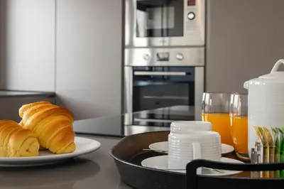 a plate of croissants on a table with orange juice at Ribeira Apartments Santa Catarina in Porto