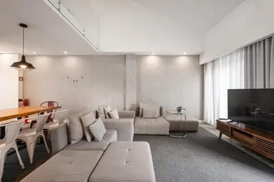 a living room with a couch and a tv at Ribeira Apartments Santa Catarina in Porto