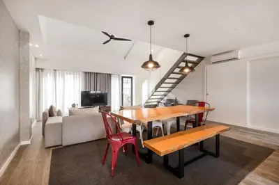 a dining room with a table and chairs and a couch at Ribeira Apartments Santa Catarina in Porto