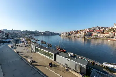 a river with a train station next to a city at YOUROPO - Ribeira Gaia in Vila Nova de Gaia
