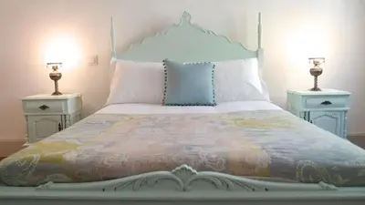 a bedroom with a bed with two night stands at BS Villas Porto in Porto