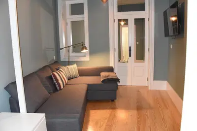 a living room with a couch and a door at Porto Traveler Apartment in Porto